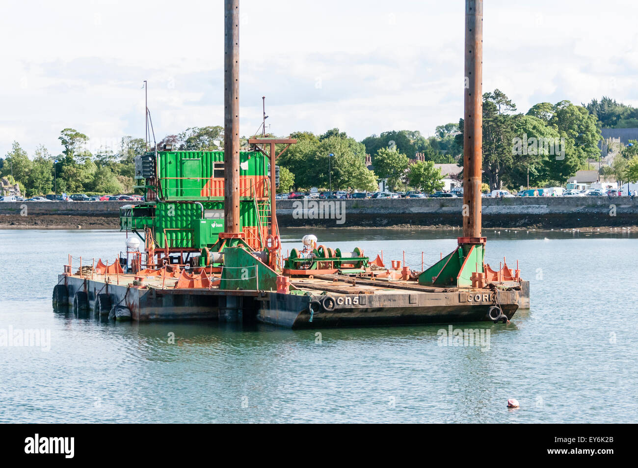 A floating jackup rig barge for construction works at a harbour.  The barge is towed into position, then the legs lowered to lift it out of the water. Stock Photo