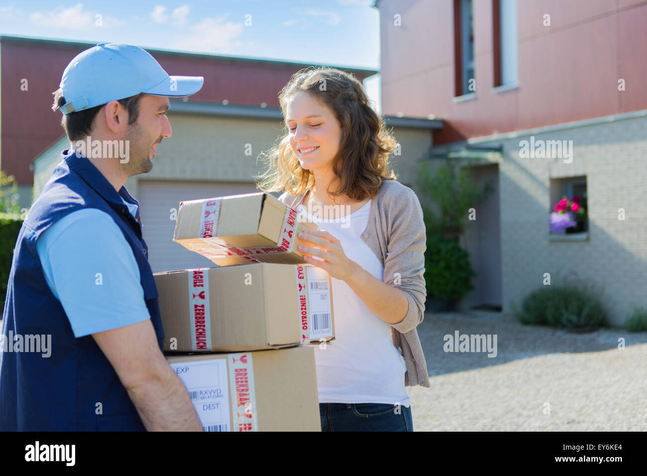 View of a Young attractive woman checking her parcel Stock Photo - Alamy