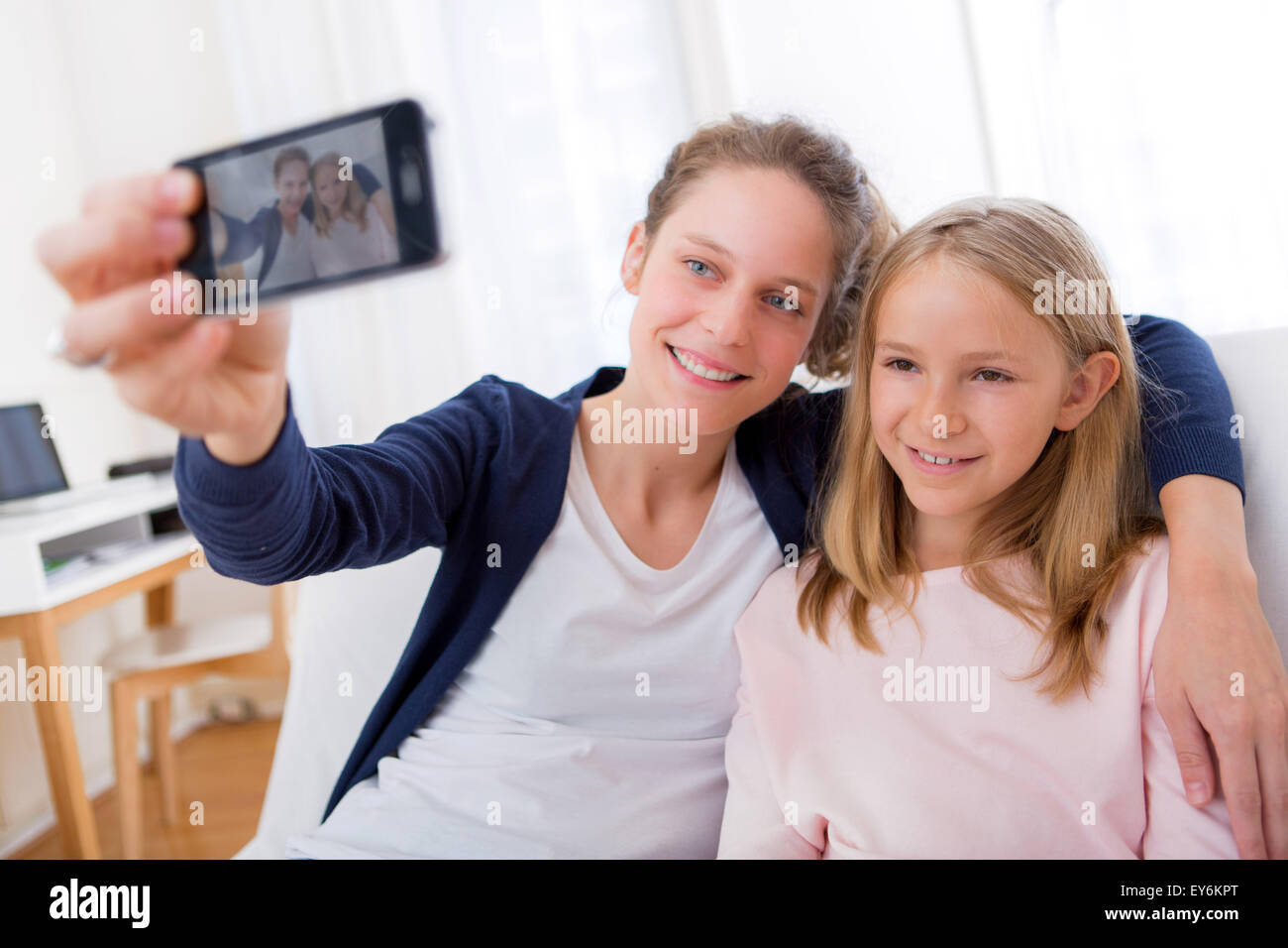View of an Attractive woman and little sister taking selfie Stock Photo
