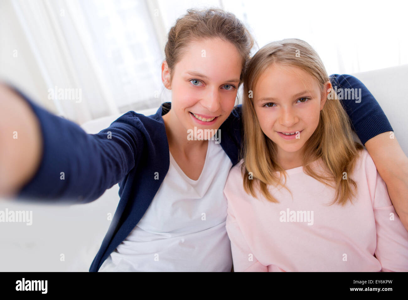 View of an Attractive woman and little sister taking selfie Stock Photo