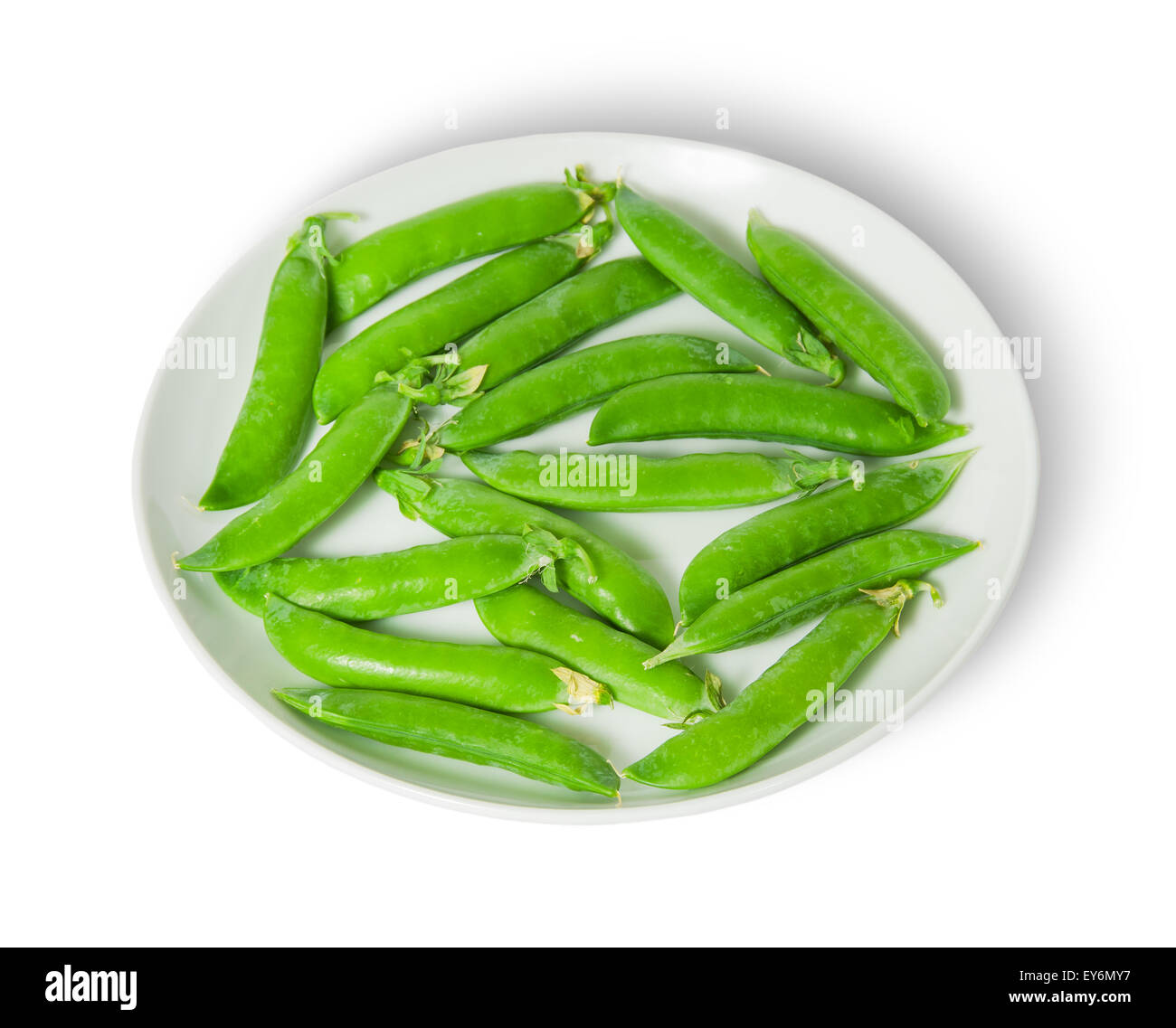 Several pods of peas on a white plate isolated on white background Stock Photo