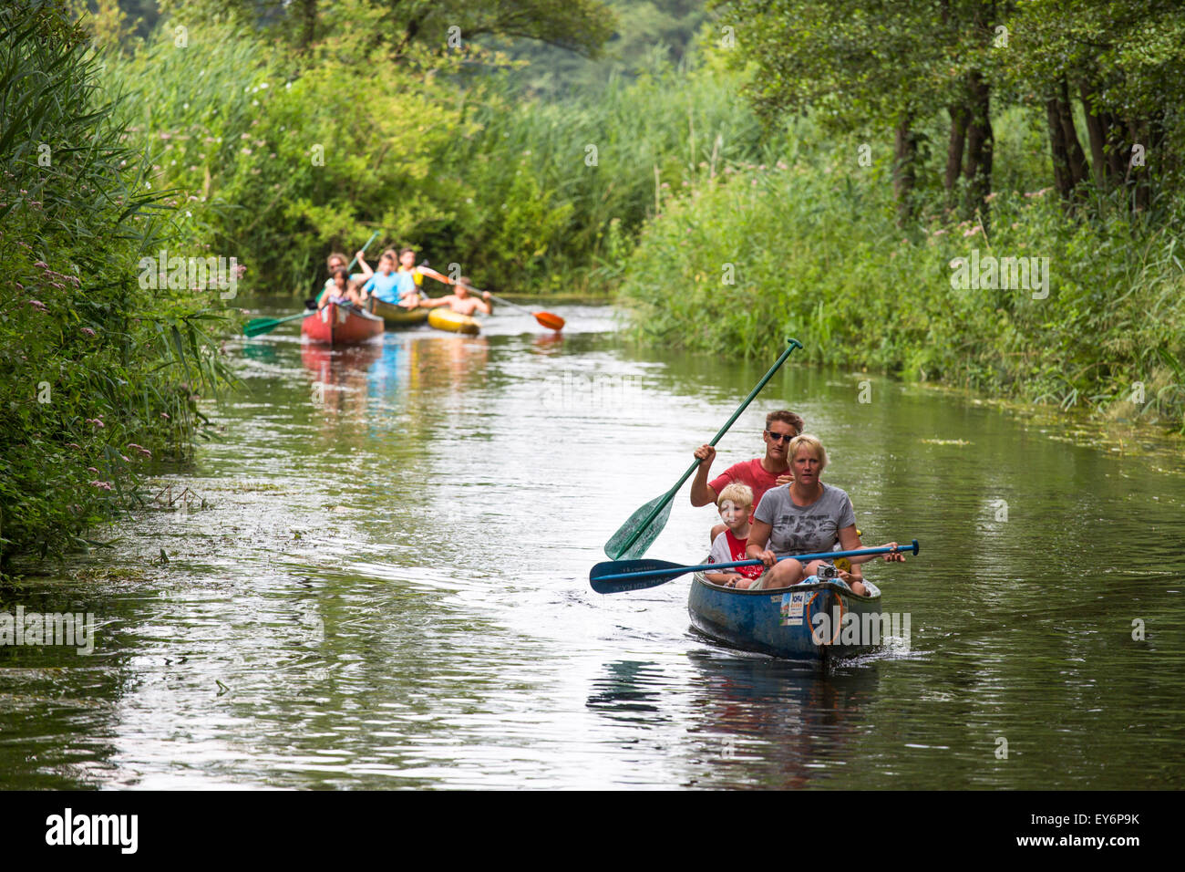Canoeing tourists passing at meandering river the 'Dommel' in the Netherlands Stock Photo