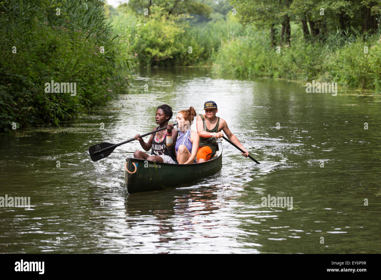 Canoeing tourists passing at river the 'Dommel' in the Netherlands Stock Photo