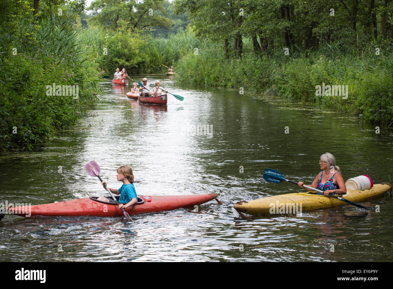Canoeing and kayaking tourists passing at meandering river the 'Dommel' in the Netherlands, Europe Stock Photo