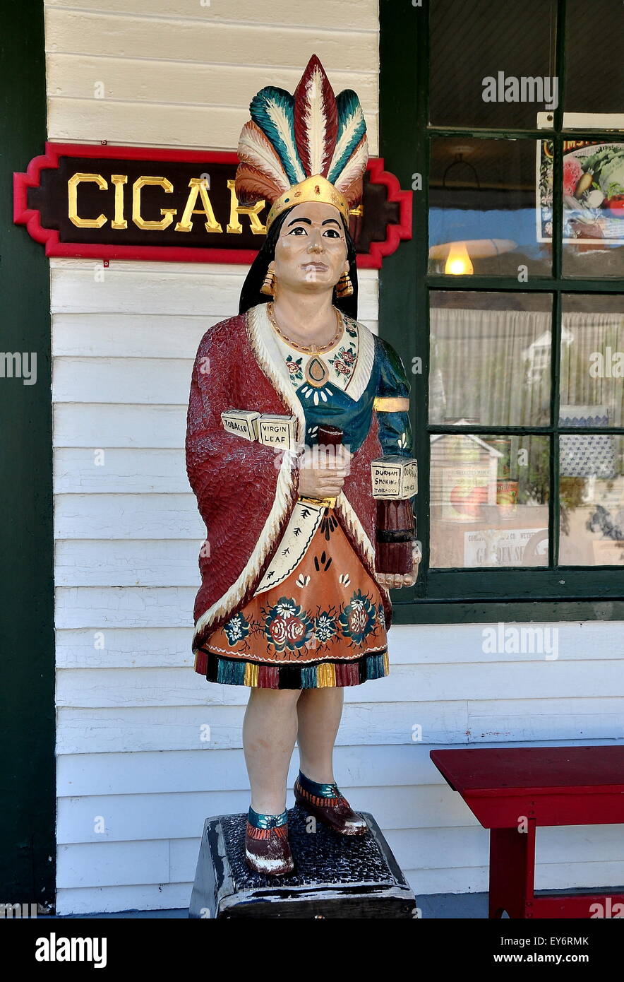 Mystic, Connecticut:  A wooden Cigar Store Indian on the porch of the Geo. H. Stone & Co. general store at Mystic Seaport Stock Photo