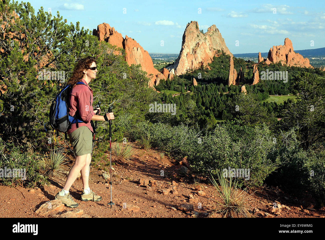 A hiker enjoys the expansive view into the Central Garden from one of the many trails in the Garden of the Gods. The Garden of the Gods is one of the most popular city parks in the United States and offers urban hiking, rock climbing, horseback riding and cycling within just a few minutes of the city of Colorado Springs, Colorado. Stock Photo