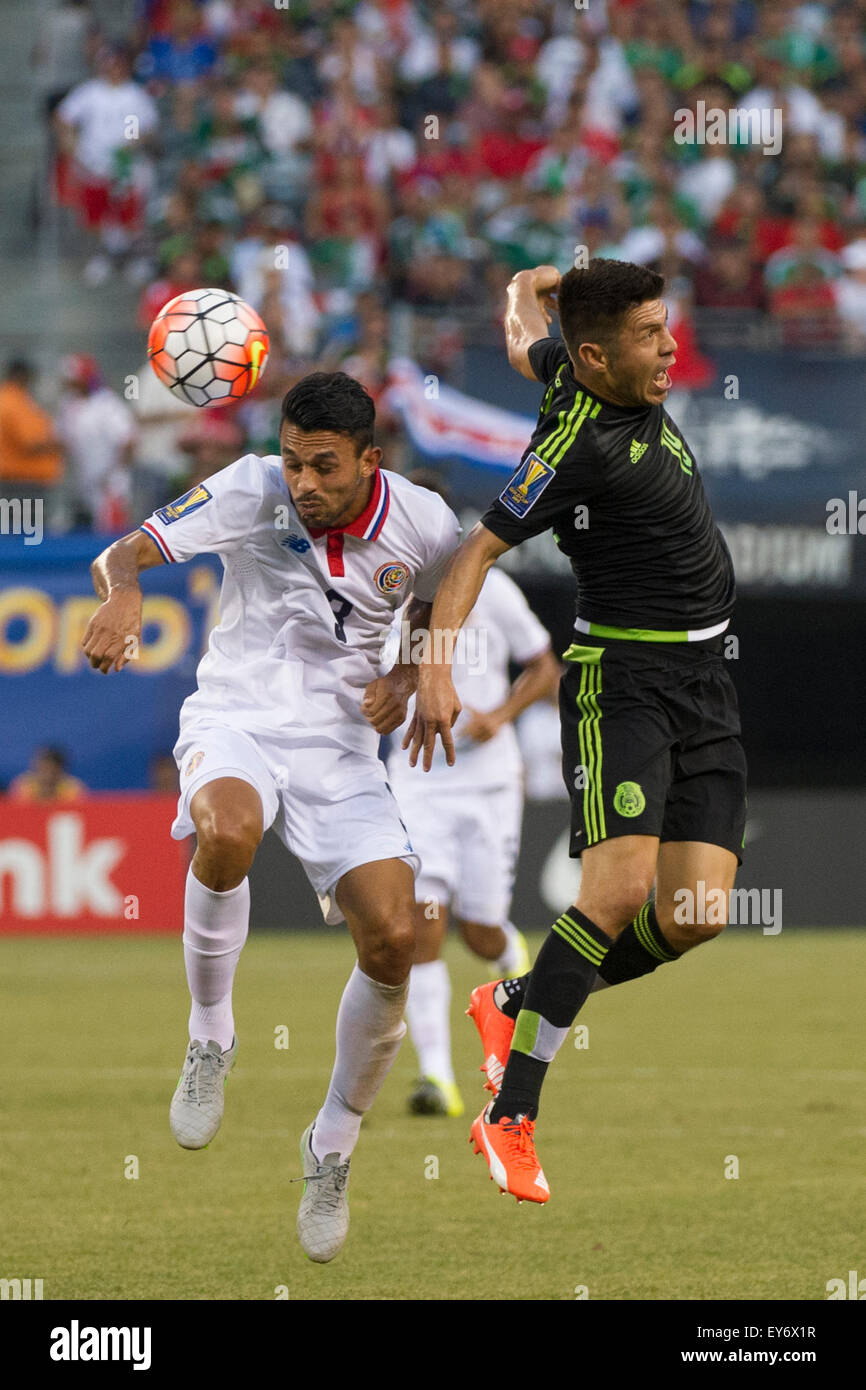 Extra Time. 19th July, 2015. Mexico forward Oribe Peralta (19) gets twisted after battling for the ball with Costa Rica defender Giancarlo Gonzalez (3) during the quarter-finals of The CONCACAF Gold Cup match between Mexico and Costa Rica at Met Life Stadium, East Rutherford, NJ. Mexico defeated Costa Rica 1-0 in the final minute of extra time. Mandatory Credit: Kostas Lymperopoulos/CSM/Alamy Live News Stock Photo