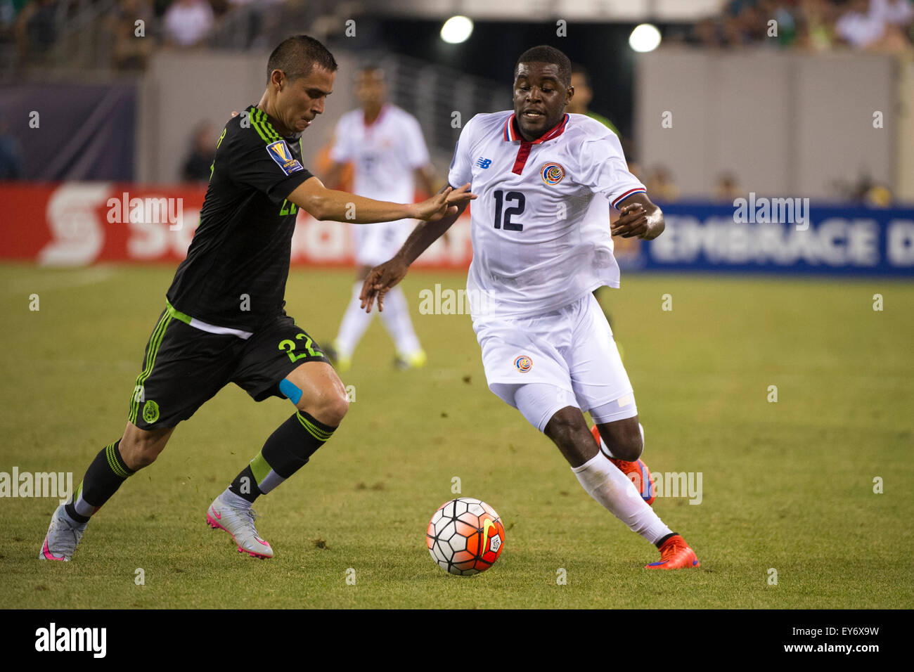 Extra Time. 19th July, 2015. Costa Rica forward Joel Campbell (12) is in action along with Mexico defender Paul Aguilar (22) during the quarter-finals of The CONCACAF Gold Cup match between Mexico and Costa Rica at Met Life Stadium, East Rutherford, NJ. Mexico defeated Costa Rica 1-0 in the final minute of extra time. Mandatory Credit: Kostas Lymperopoulos/CSM/Alamy Live News Stock Photo