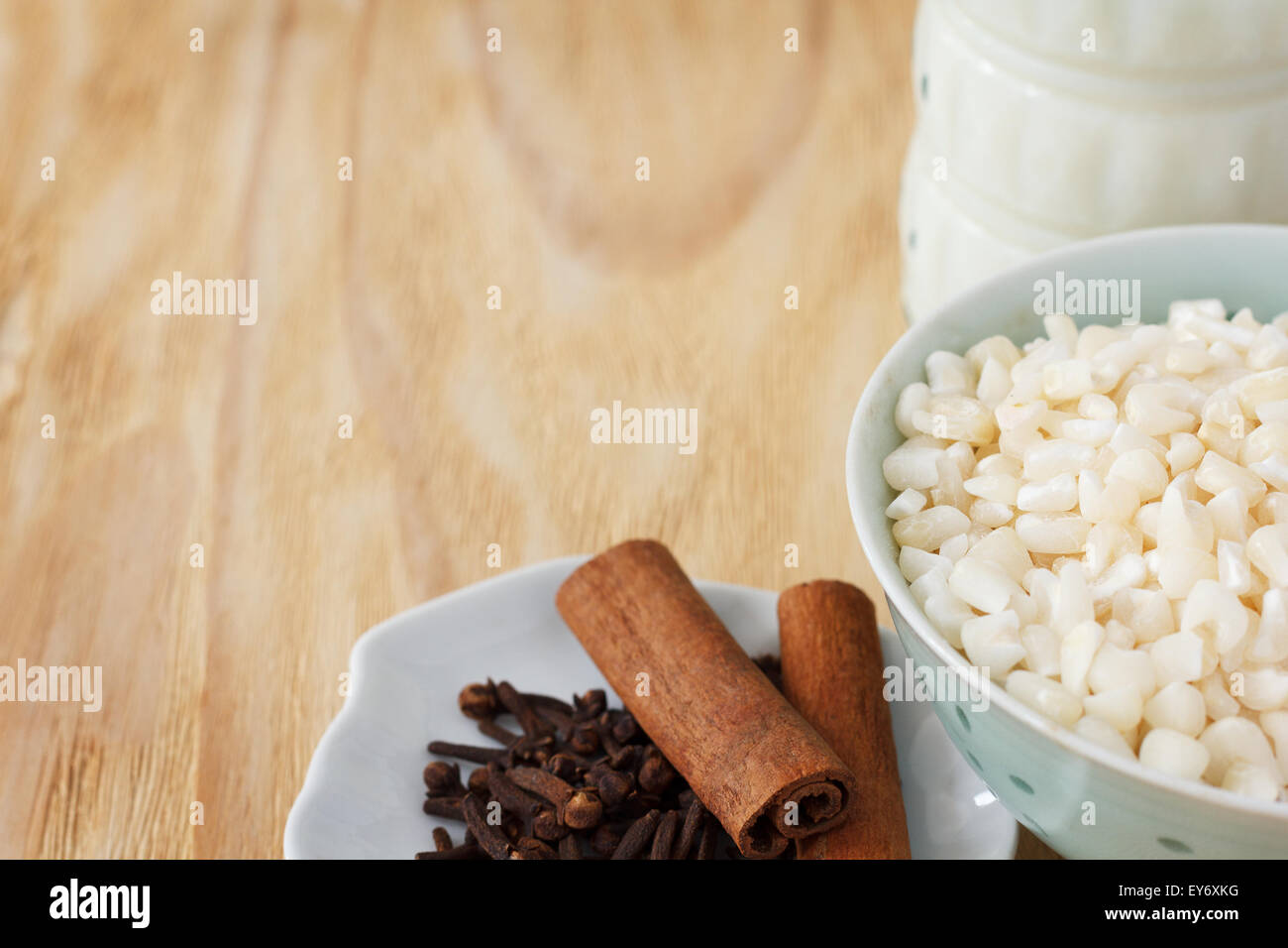 Cooking brazilian dessert canjica of white corn kernels with cinnamon