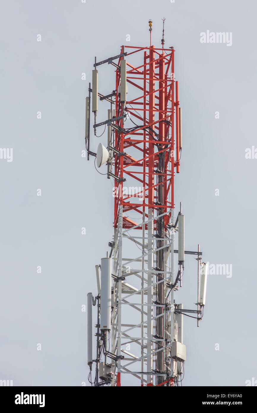Close up white color antenna repeater tower on blue sky Stock Photo