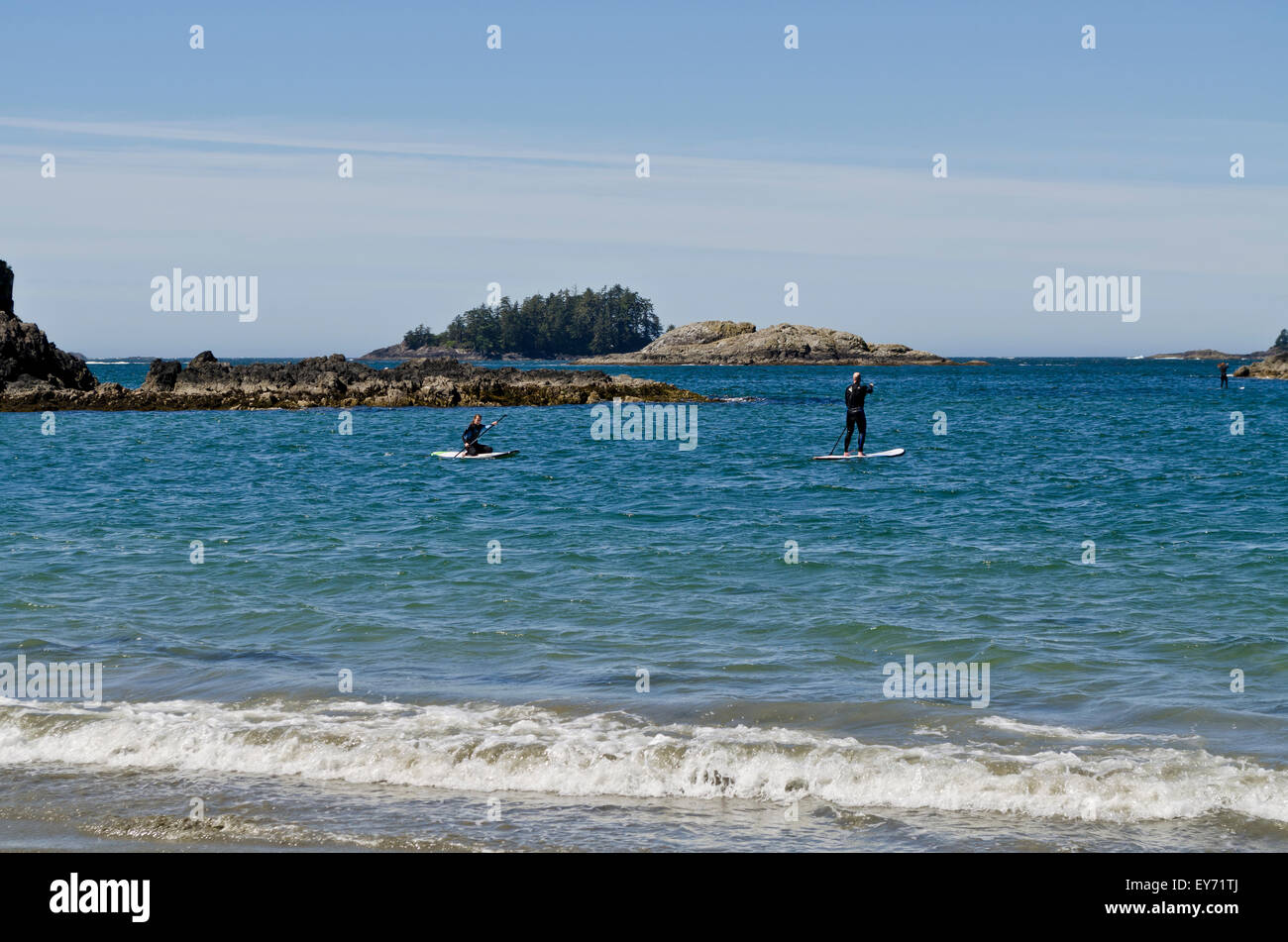 Stand up paddle board users on the waters off Chesterman Beach near Tofino on Vancouver Island, BC, Canada Stock Photo
