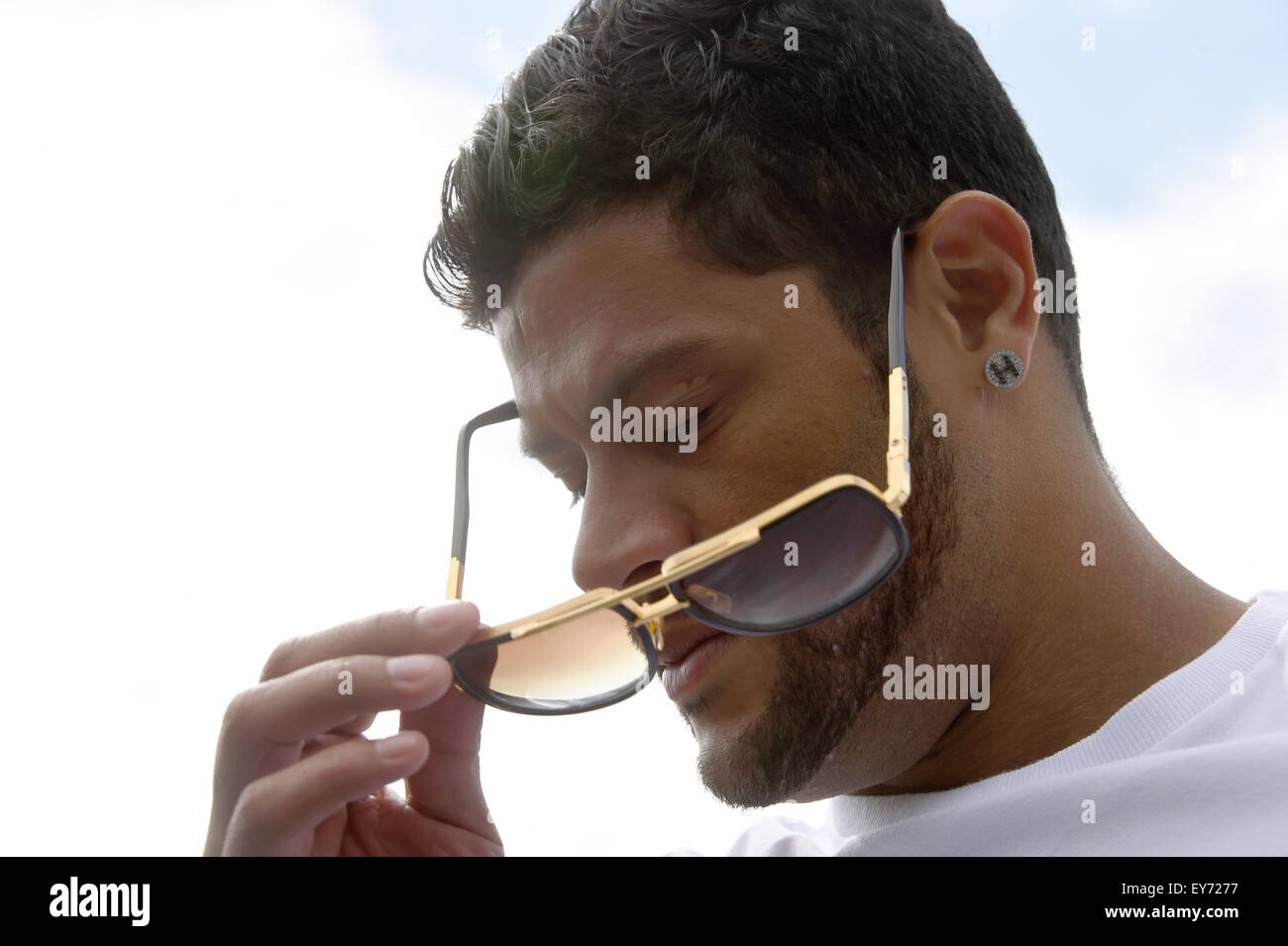 Brazilian national player and player of FC Zenit St. Petersburg, Hulk, pus on his sunglasses on the training grounds in St. Petersburg, Russia, 20 July 2015. Racist comments are part of the everyday life in Russian soccer, Hulk said. 'That happens during every match in the Russian league. I used to get mad. Today I blow the supporters kisses', the striker said on Monday. Photo: Marcus Brandt/dpa Stock Photo