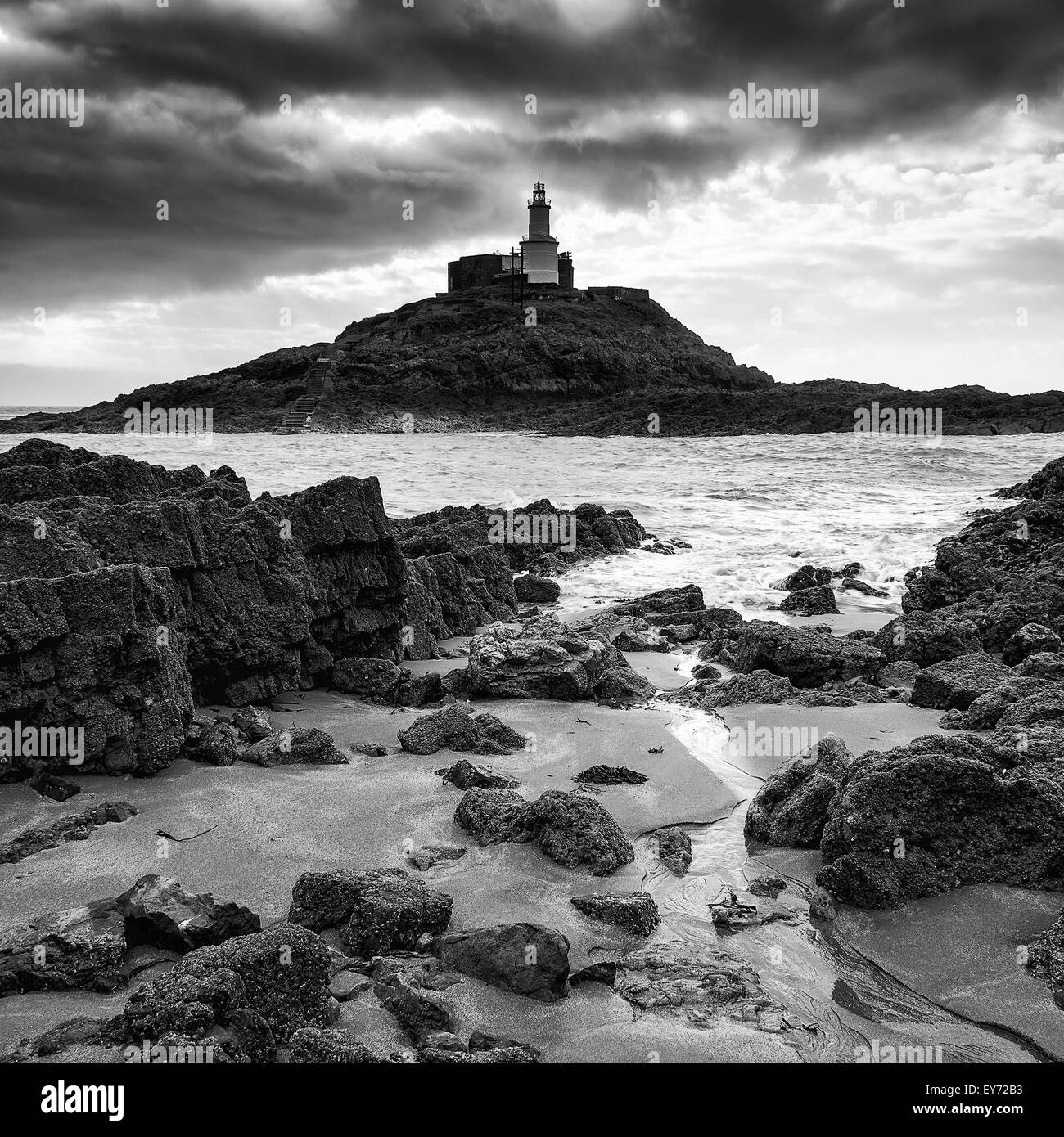 Lighthouse landscape with stormy sky over sea in black and white Stock Photo