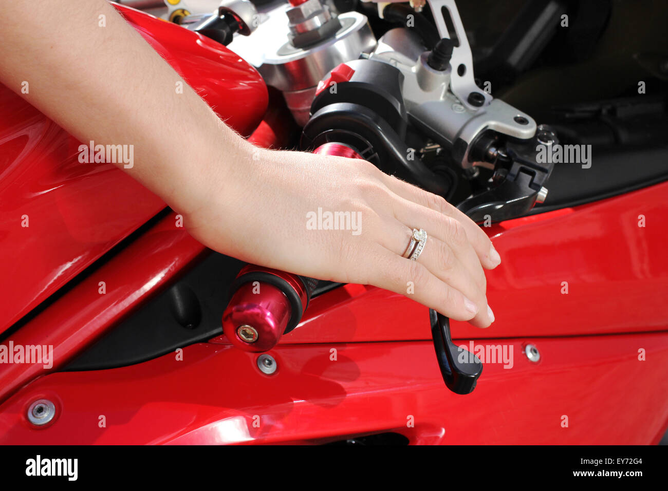 Woman hand rests on the steering wheel motorcycle Stock Photo