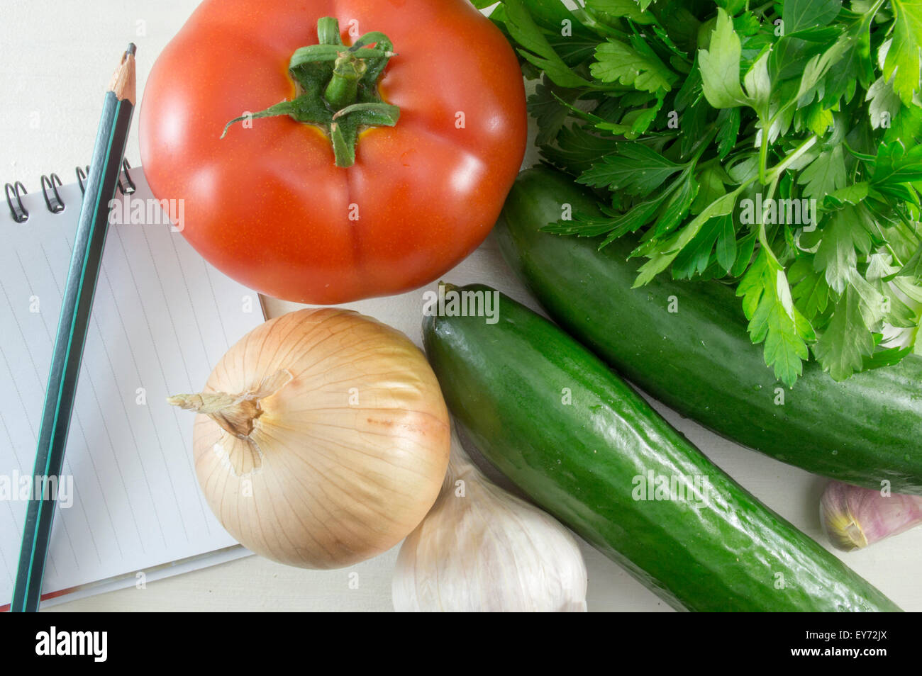 Colorful natural vegetables, pencil and notebook on the table ready for ...