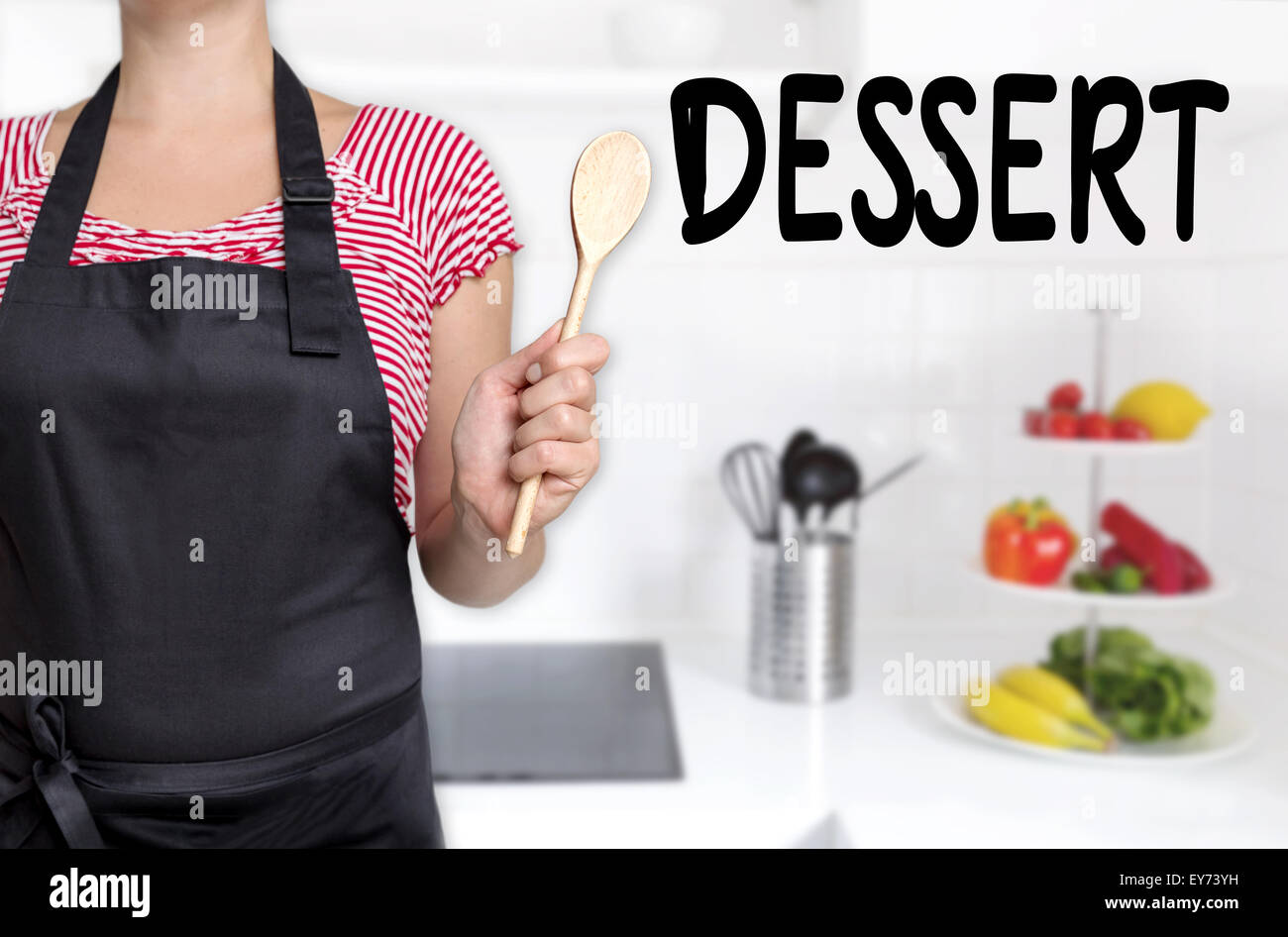 dessert cook holding wooden spoon background. Stock Photo