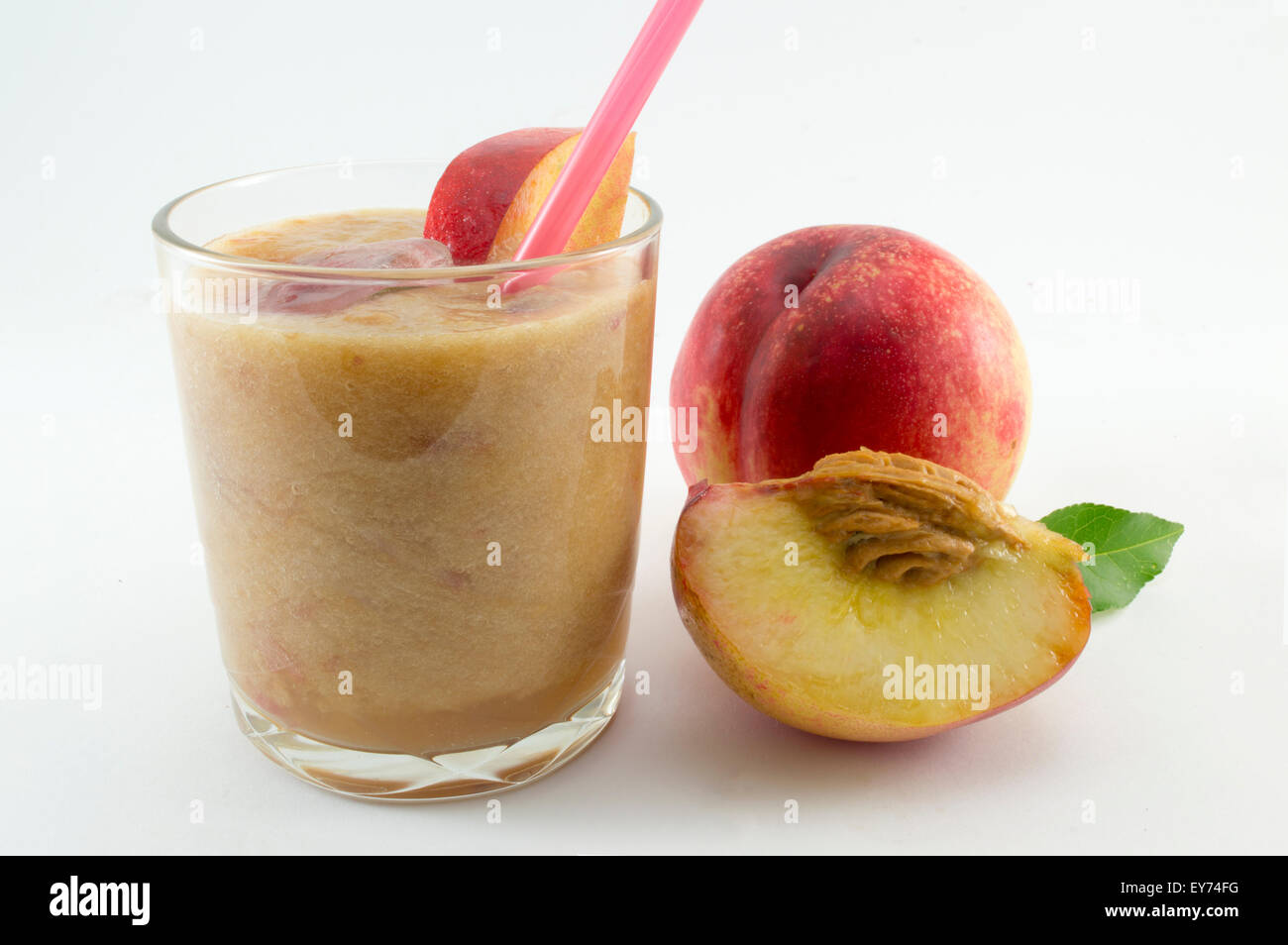 Freshly squeezed natural peach juice and fresh peaches on white Stock Photo