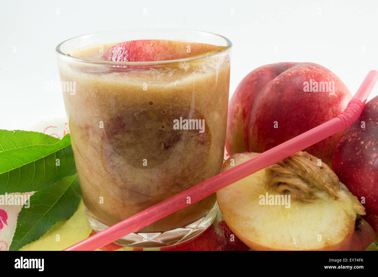 Freshly squeezed natural peach juice and fresh peaches on white Stock Photo