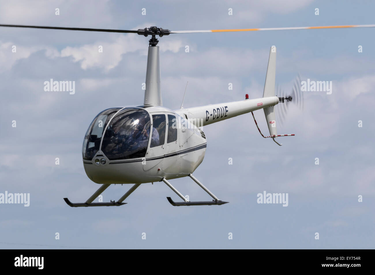 Robinson R44 helicopter, reg G-CDUE, flying at Breighton Stock Photo ...