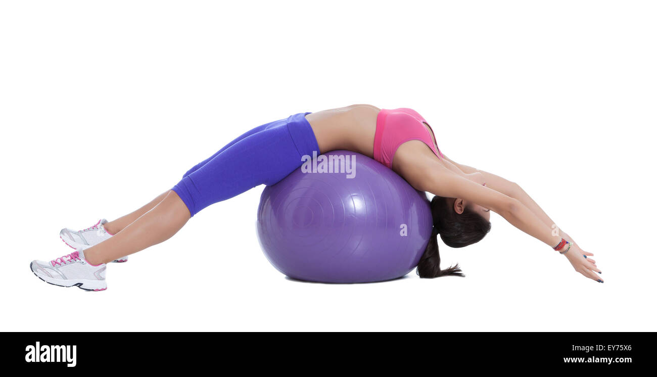 Sit on an exercise ball, lean back and walk your feet out so the ball is now underneath your spine. Keep your knees bent and you Stock Photo