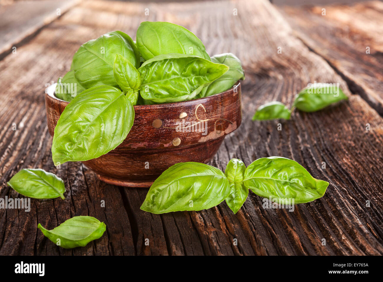 Fresh basil herbs in wooden bowl on old wooden brown background ...