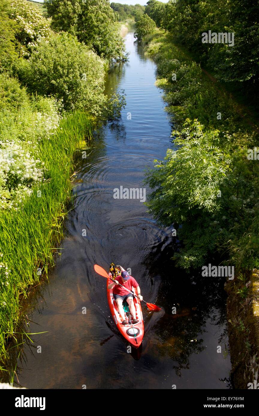 kayaking on Northern Reaches of Lancashire Canal on Lancashire-Cumbria border where not navigable by narrowboat Stock Photo