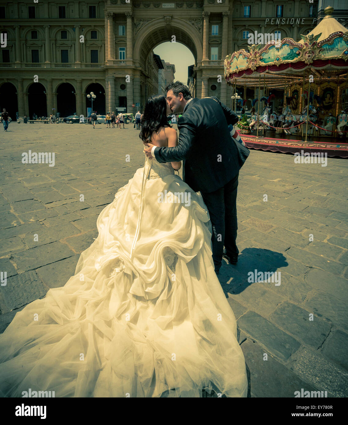 Bride and groom kissing in Piazzo della Repubblica, Florence, Italy. Stock Photo