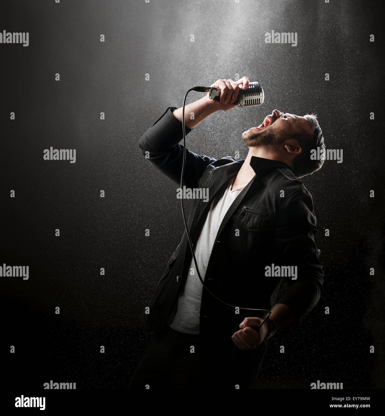 Singer performing with smoke and powder display in the background (Stan