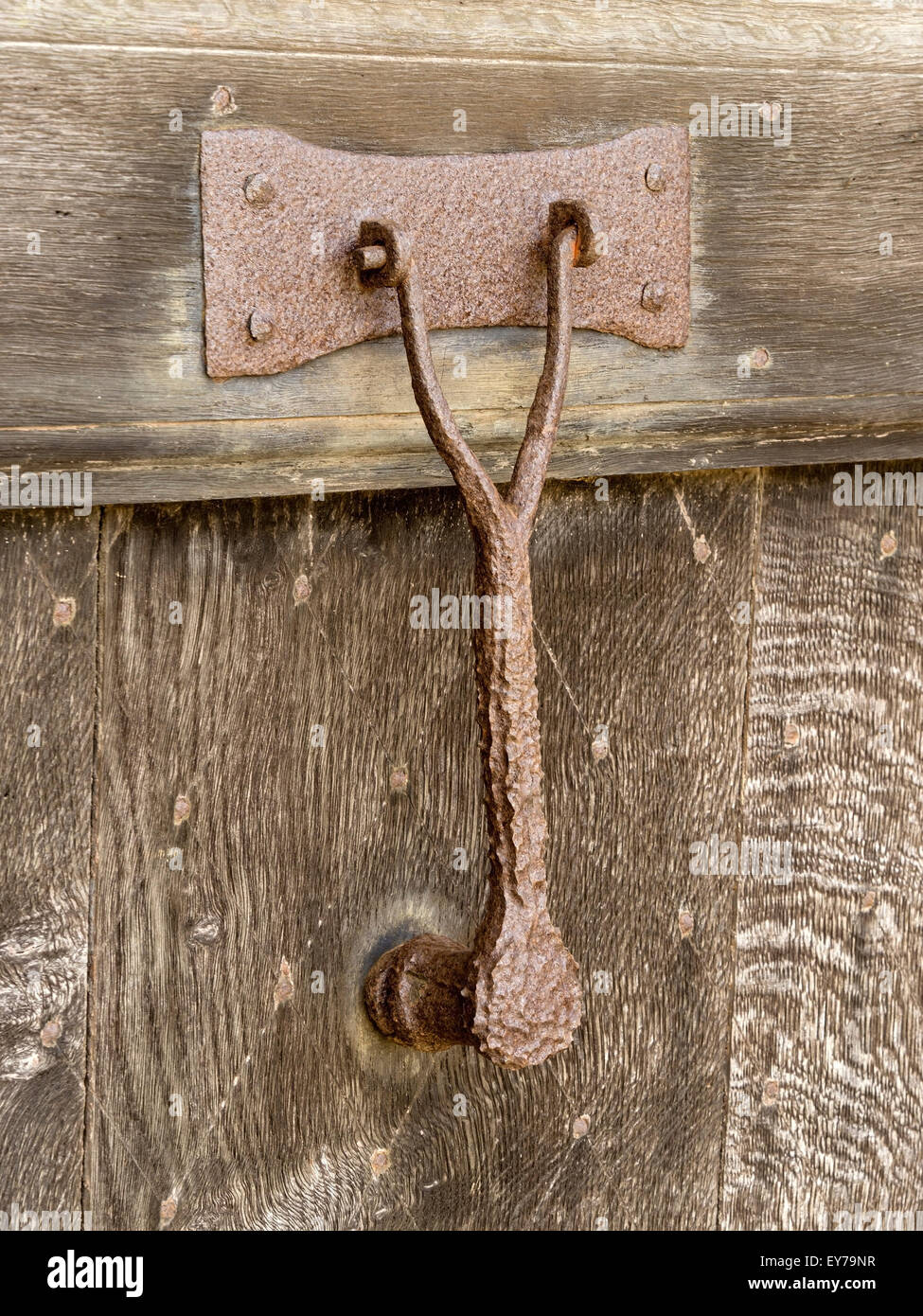 Old rusty iron door knocker on dark Oak door, Northamptonshire, England, UK. Stock Photo