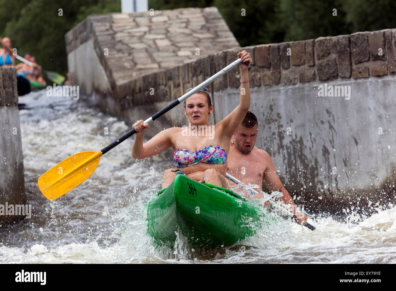 People canoeing river Vltava, Zlata Koruna weir, South Bohemia, Czech Republic enjoying summer vacation Stock Photo