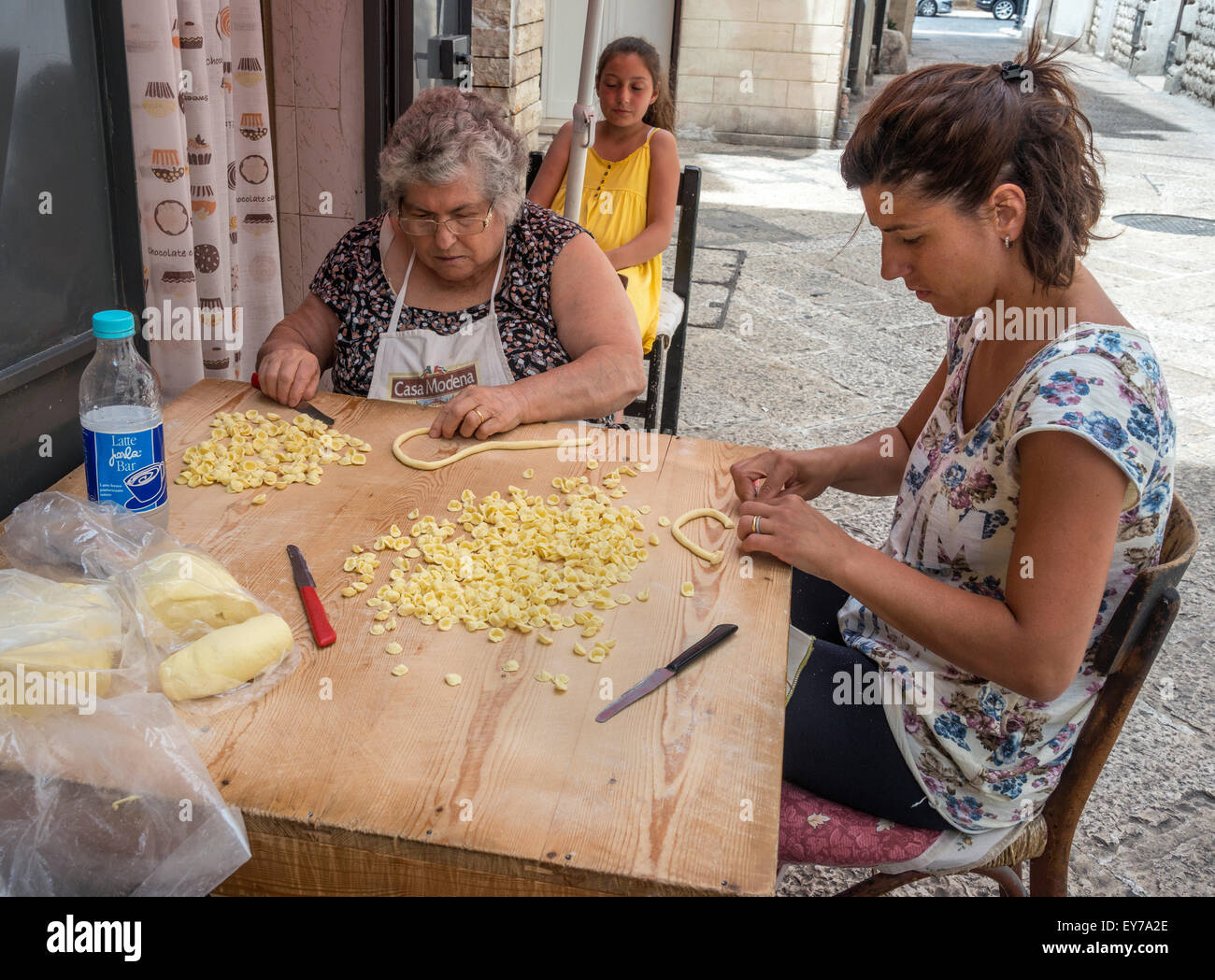 Women making orecchiette, typical puglian pasta, in a sidestreet in