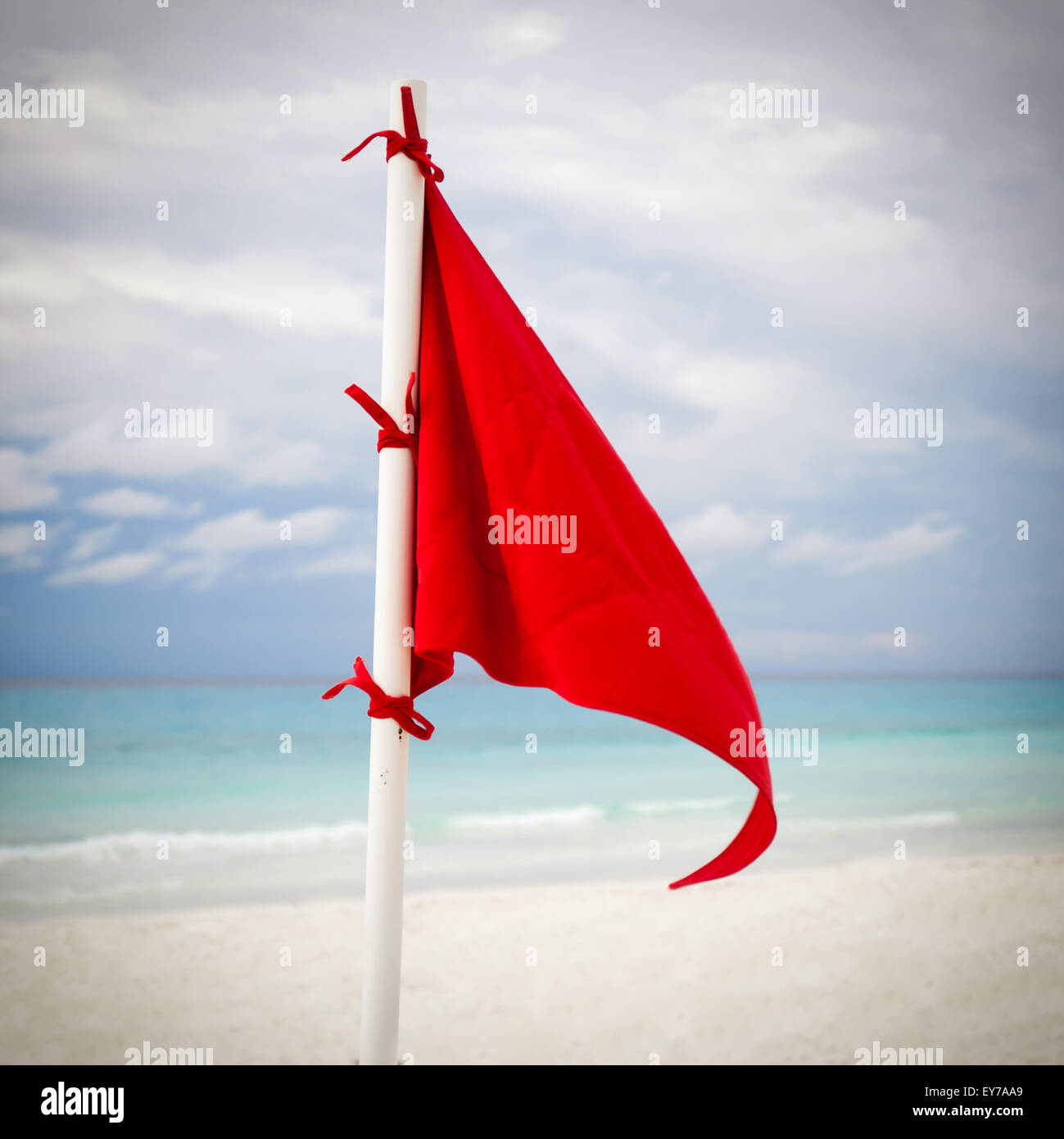 Lifeguard red flag at caribbean beach in bad weather Stock Photo