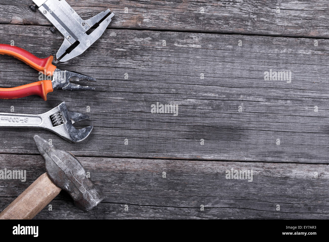 Different construction tools on a wooden background with copy space ...
