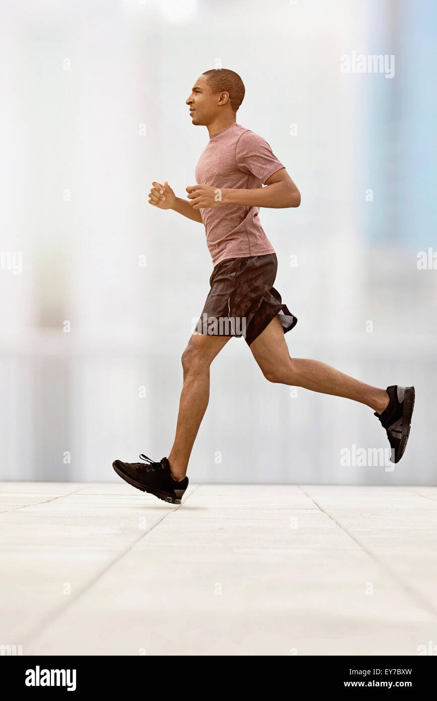 Mid adult man running Stock Photo