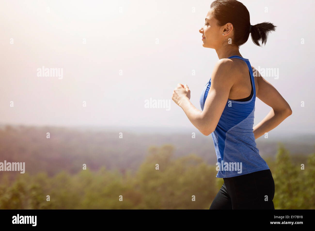 Young woman running outdoors Stock Photo