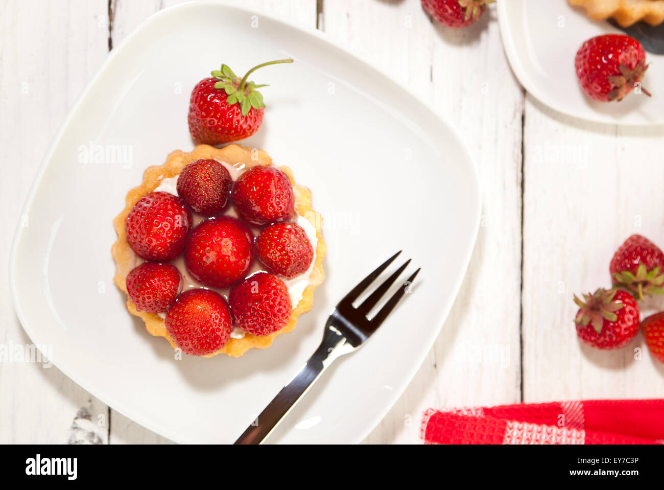 Strawberry shortcake on wooden coffee table, high angle view Stock Photo