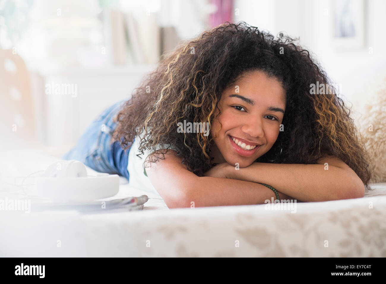 Portrait of teenage girl (16-17) lying on bed Stock Photo