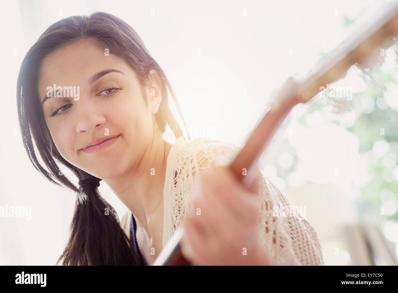 Teenage girl (14-15) playing guitar Stock Photo