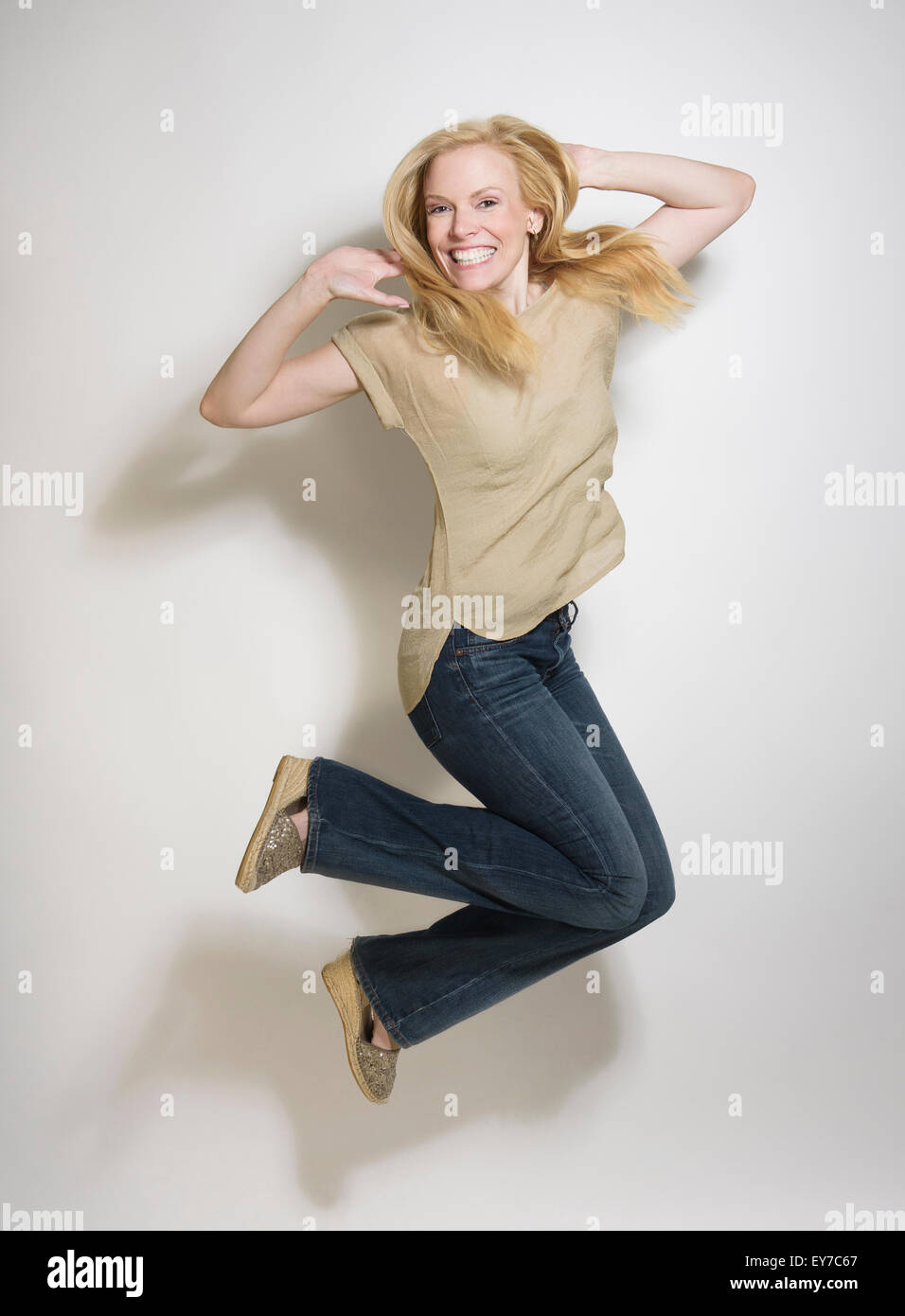 Portrait of mid-adult woman jumping Stock Photo