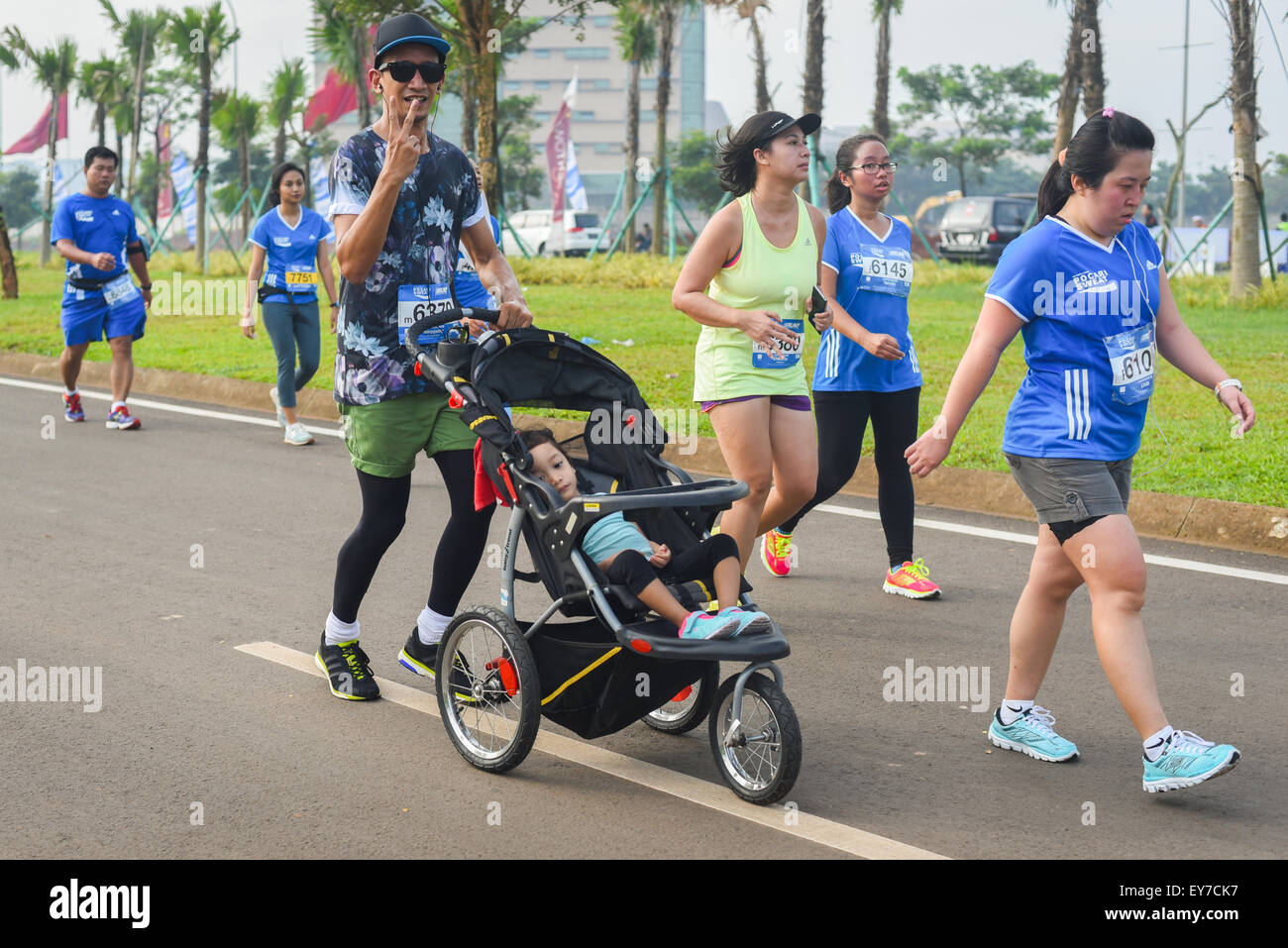 Participants running during  'Pocari Sweat Run Indonesia 2015' in Tangerang, Banten, Indonesia. Stock Photo