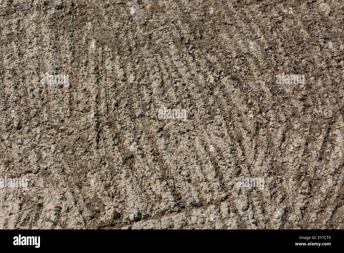 Concreted area by farm gate, showing scratched grooved surface to provide better grip for farm vehicles. Bumpy surface texture, rough texture. Stock Photo