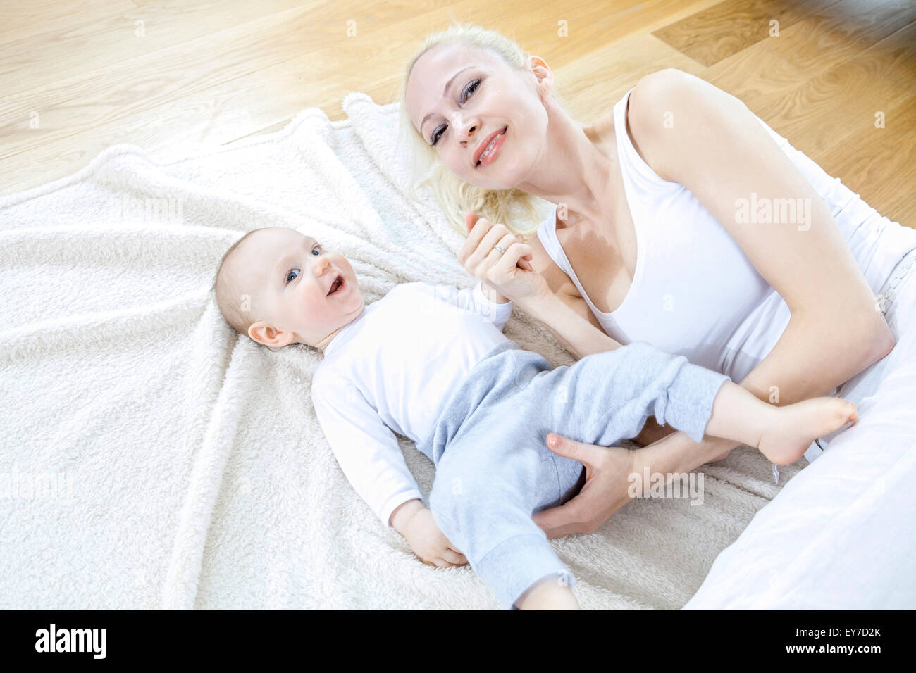 Mother and baby lying on blanket Stock Photo