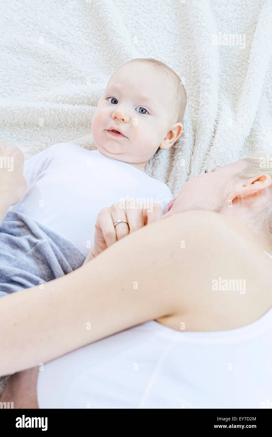 Mother and baby lying on blanket Stock Photo