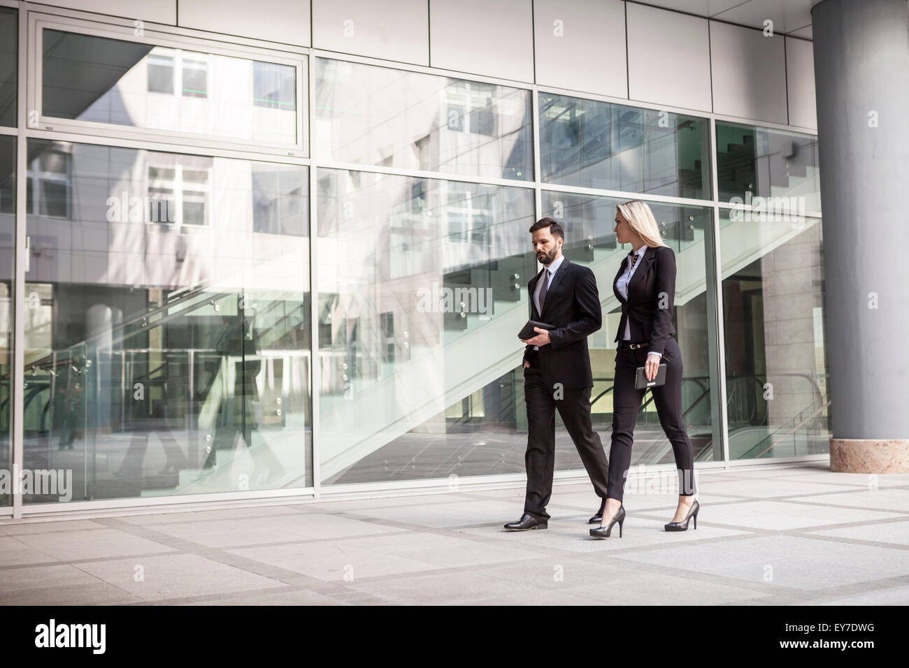 Business partners walking by office building Stock Photo
