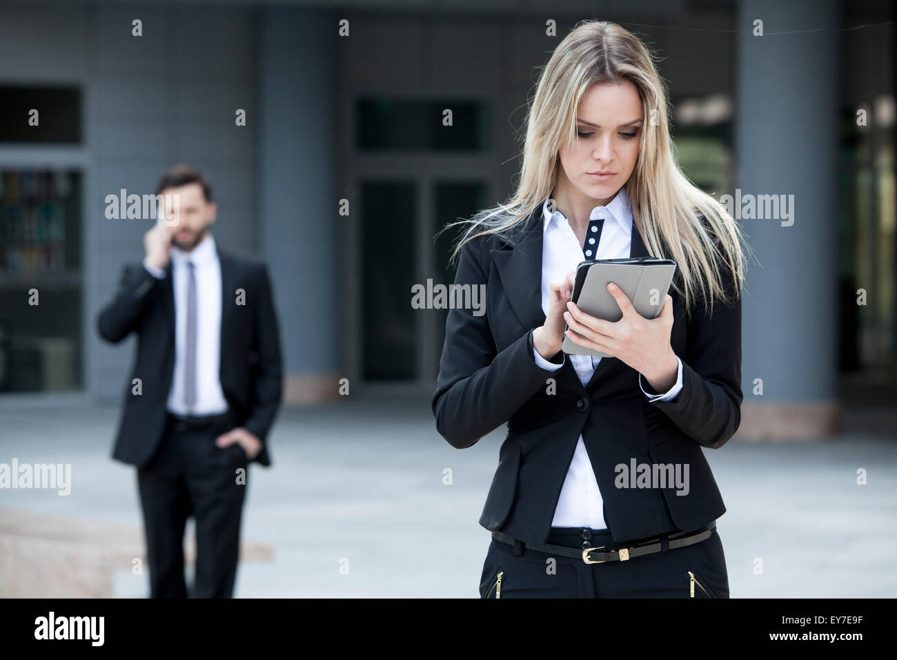 Business woman using digital tablet outdoors Stock Photo
