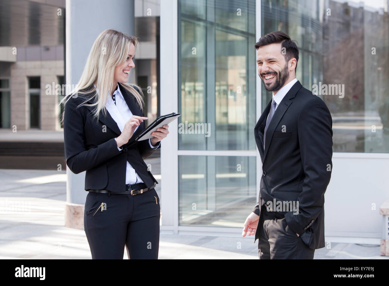 Business partners using digital tablet outdoors Stock Photo