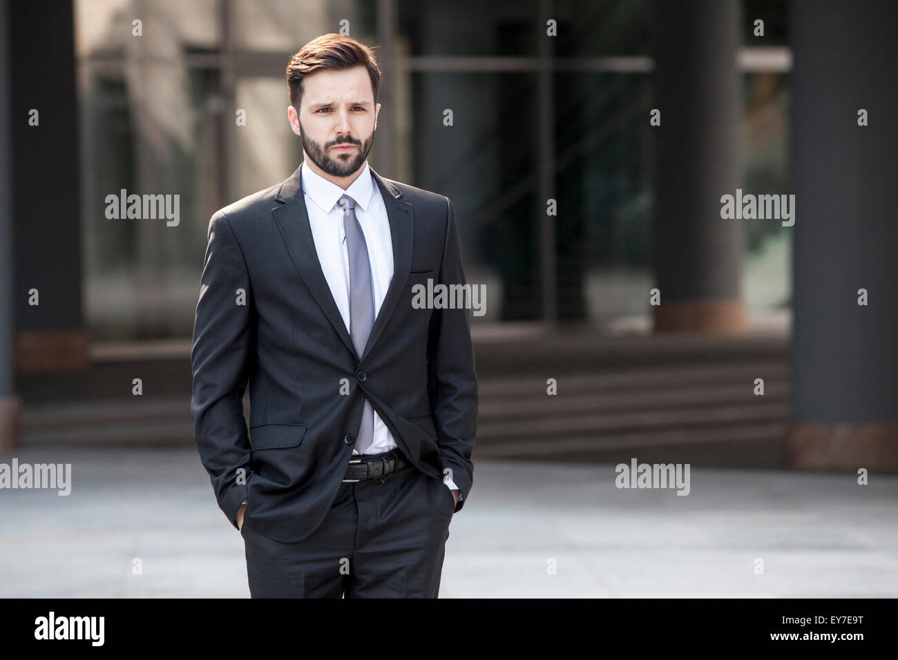 Businessman hands in pockets outdoors Stock Photo