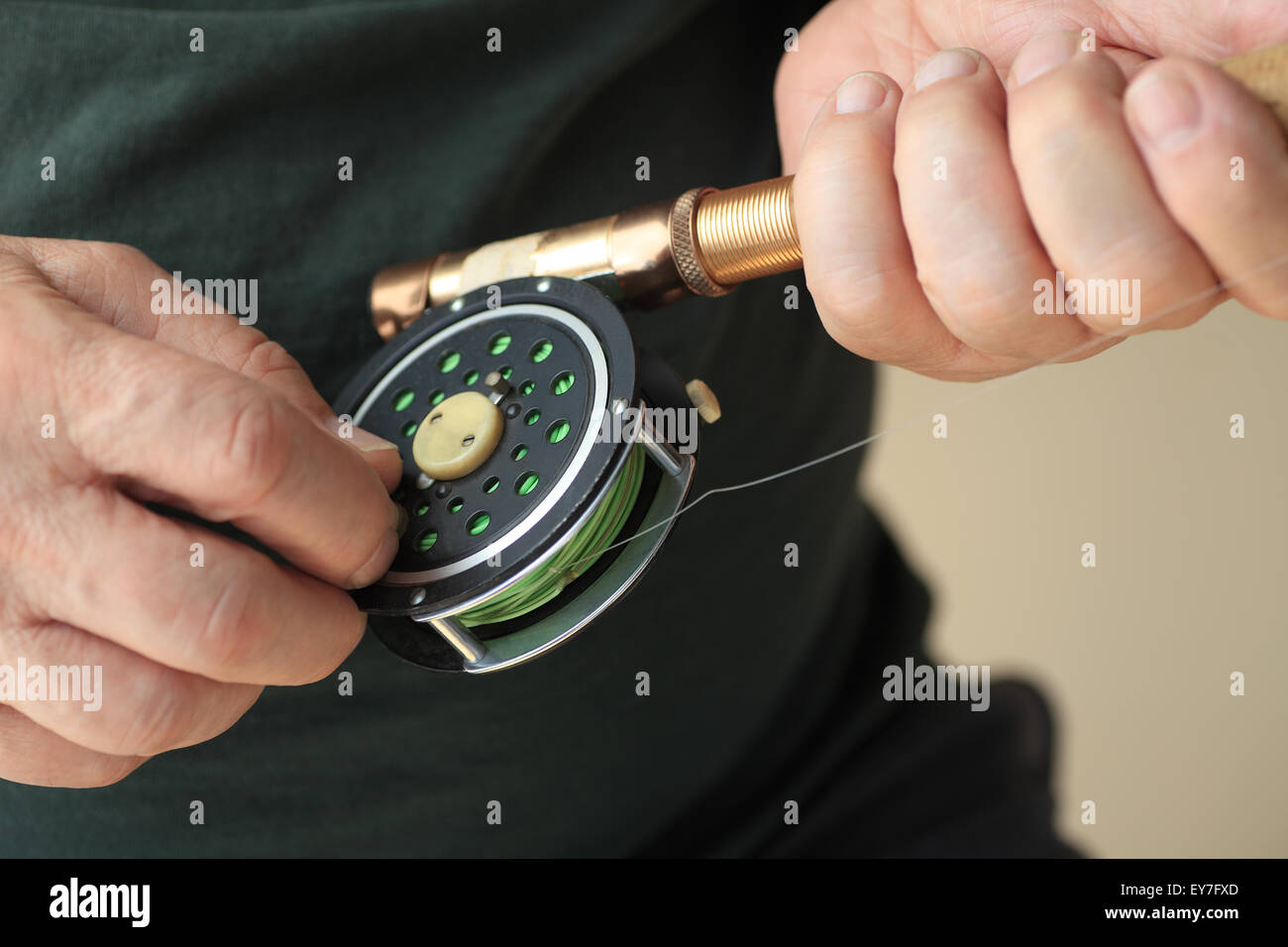 A man holds a fly fishing rod and reel. Stock Photo