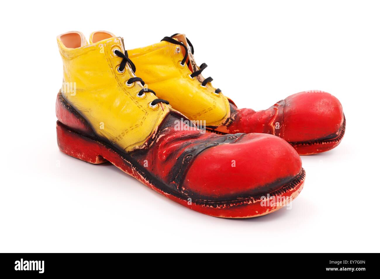 Very big red-yellow clown shoes on white Stock Photo