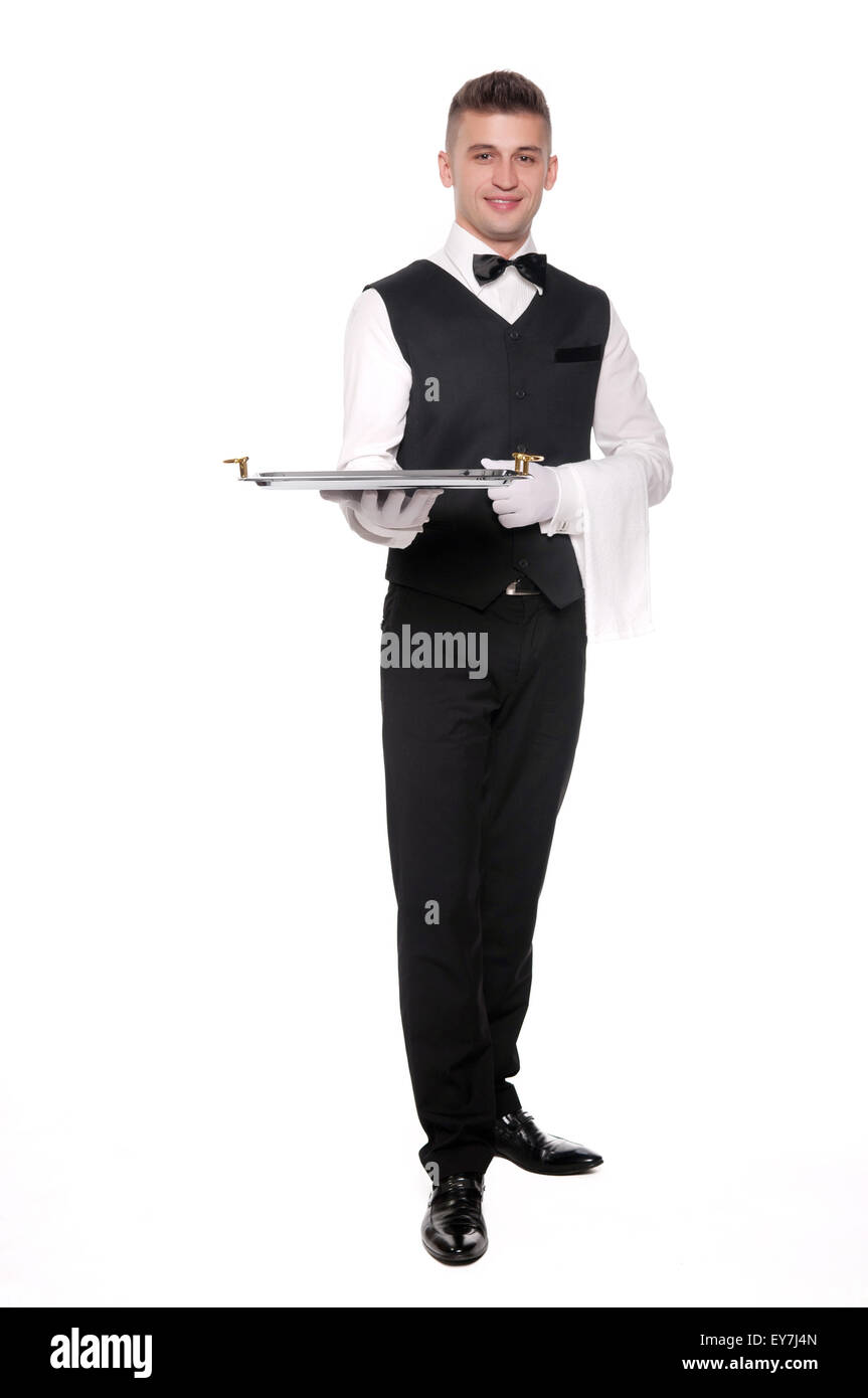 A young boy waiter with a tray. Isolated background and clipping path Stock Photo